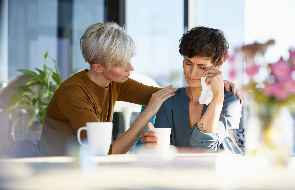 Woman consoling crying friend