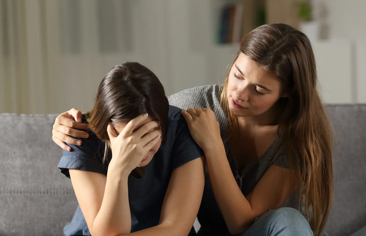 Teen comforting her sad friend in the night