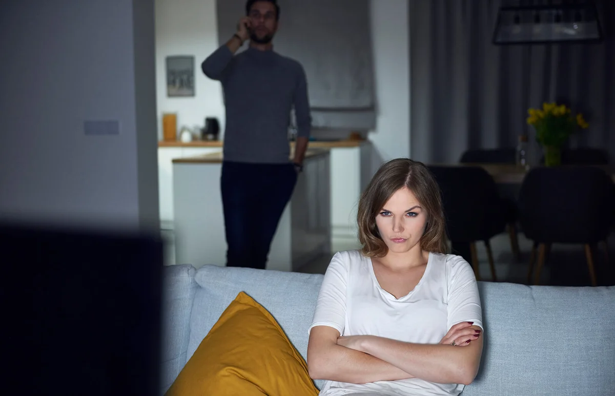 woman sulking on sofa in evening