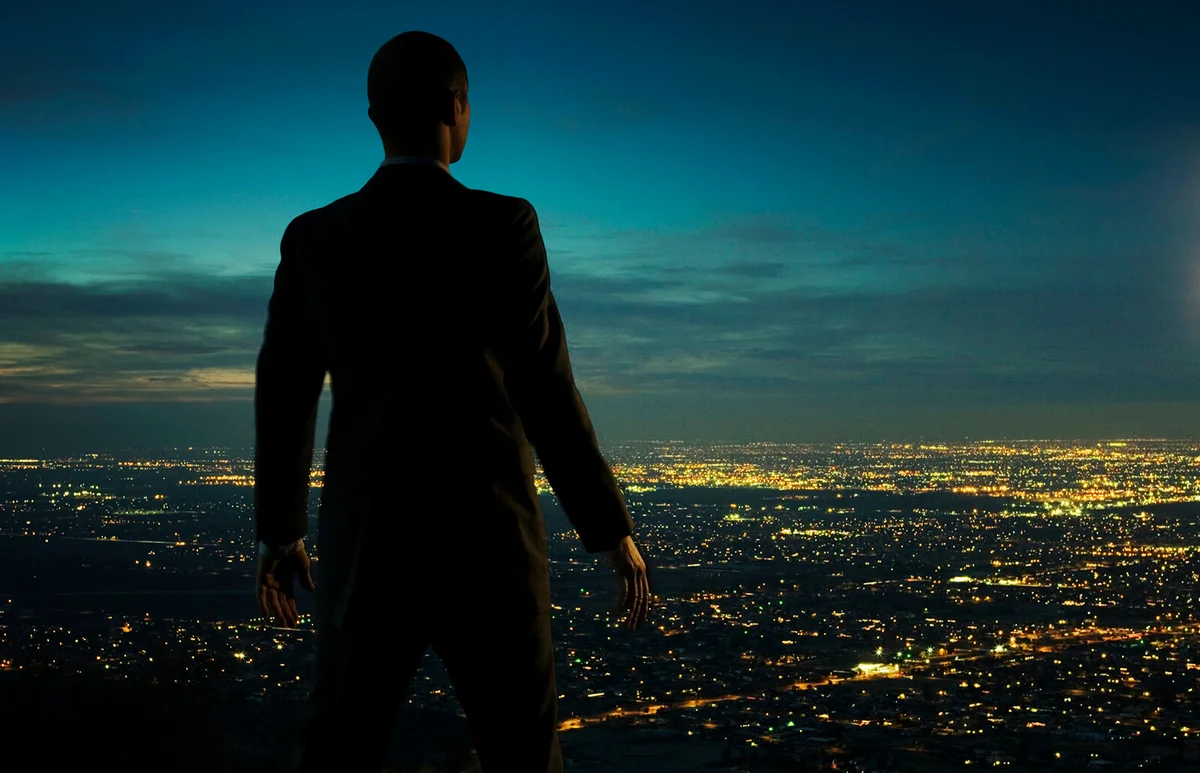 Man looking over cityscape at night
