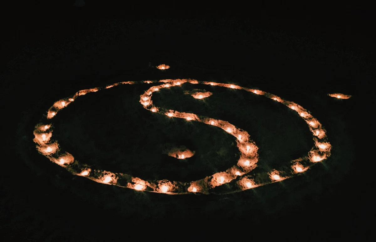 High Angle View Of Illuminated Yin Yang Symbol In Dark At Night