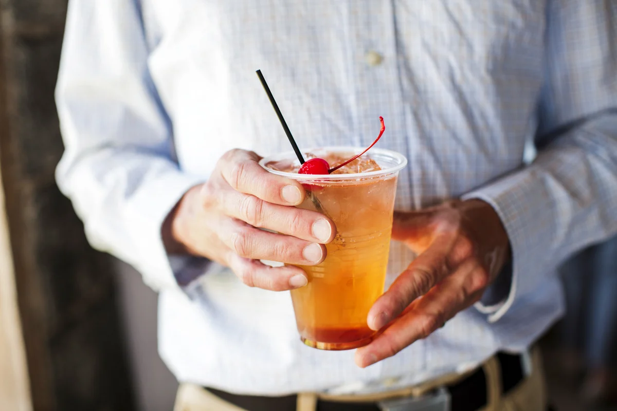 Man’s hands holding an old fashioned cocktail