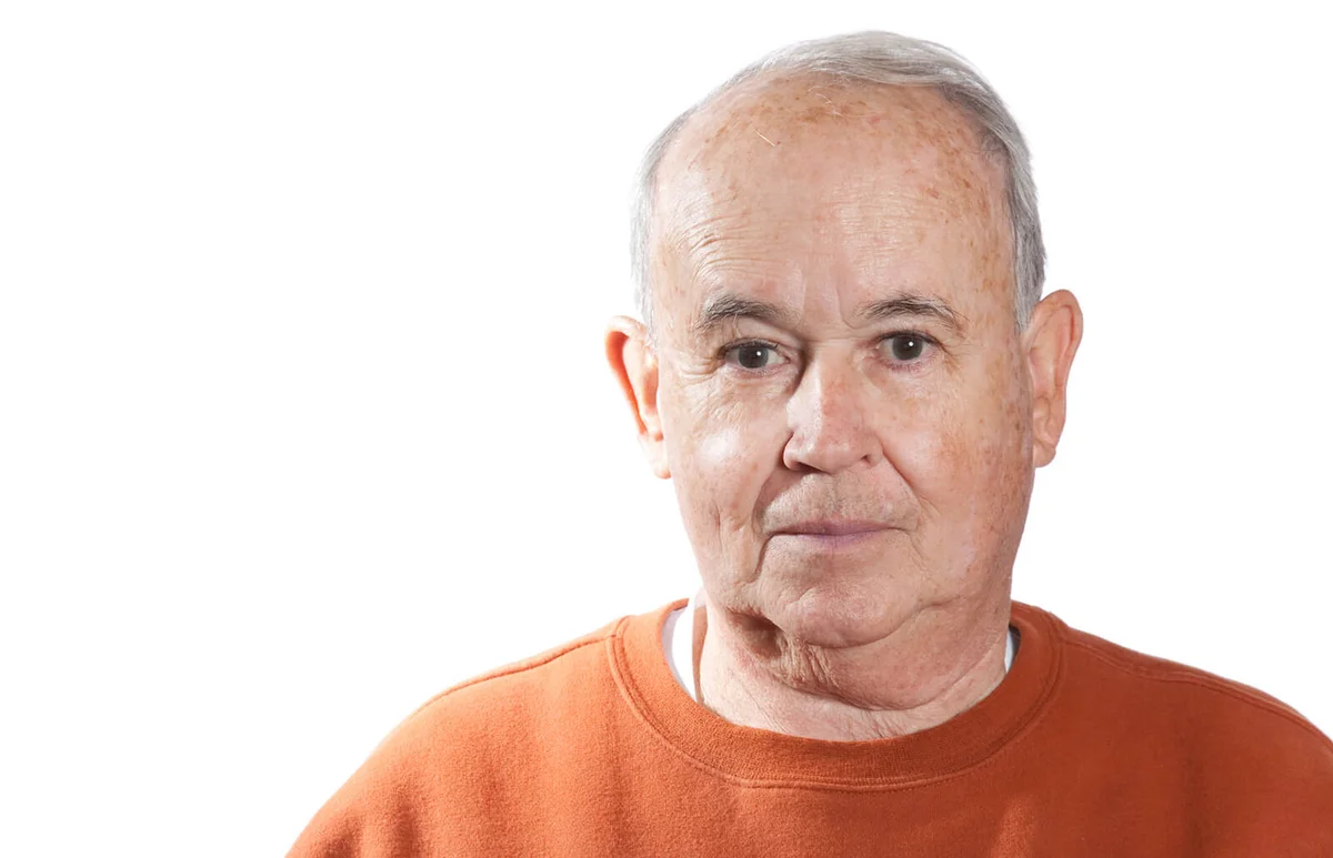 Elderly man looking into camera