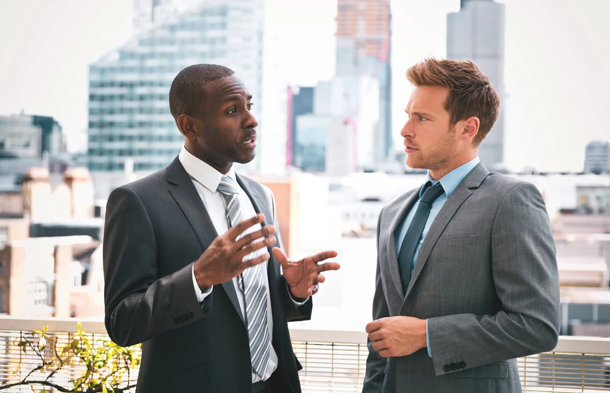 Two professional businessmen talking