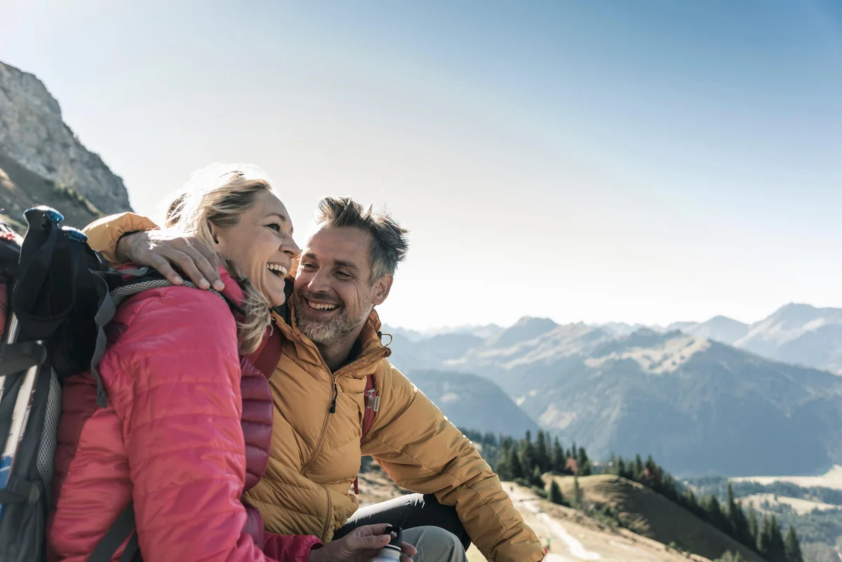 happy couple having a break during a hiking trip