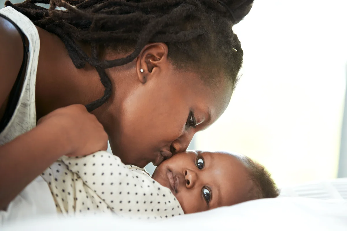 Mother and her newborn baby at home