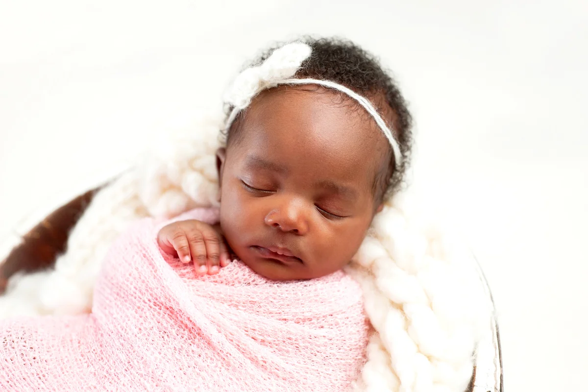 Newborn Baby Girl Sleeping in Bowl