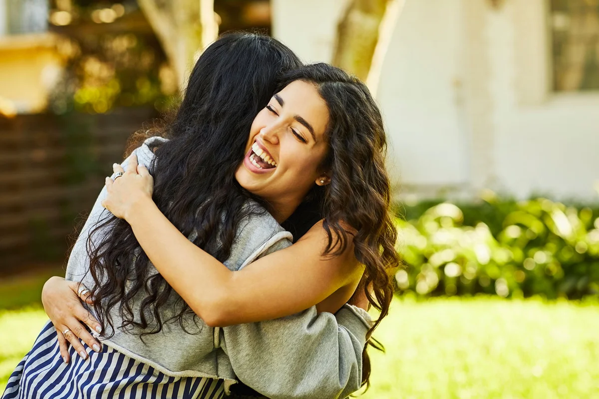 Two women friends embracing