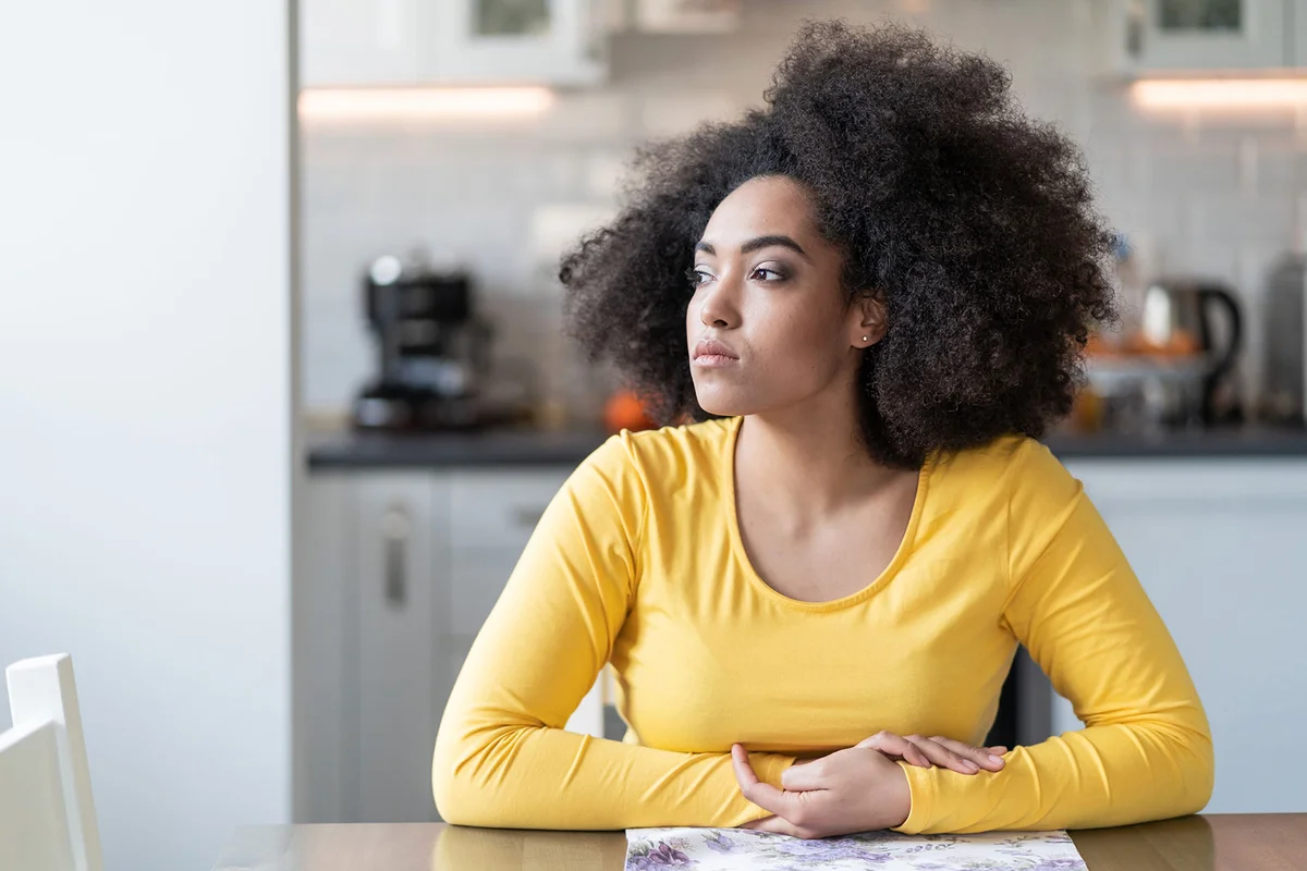 Woman sitting in kitchen