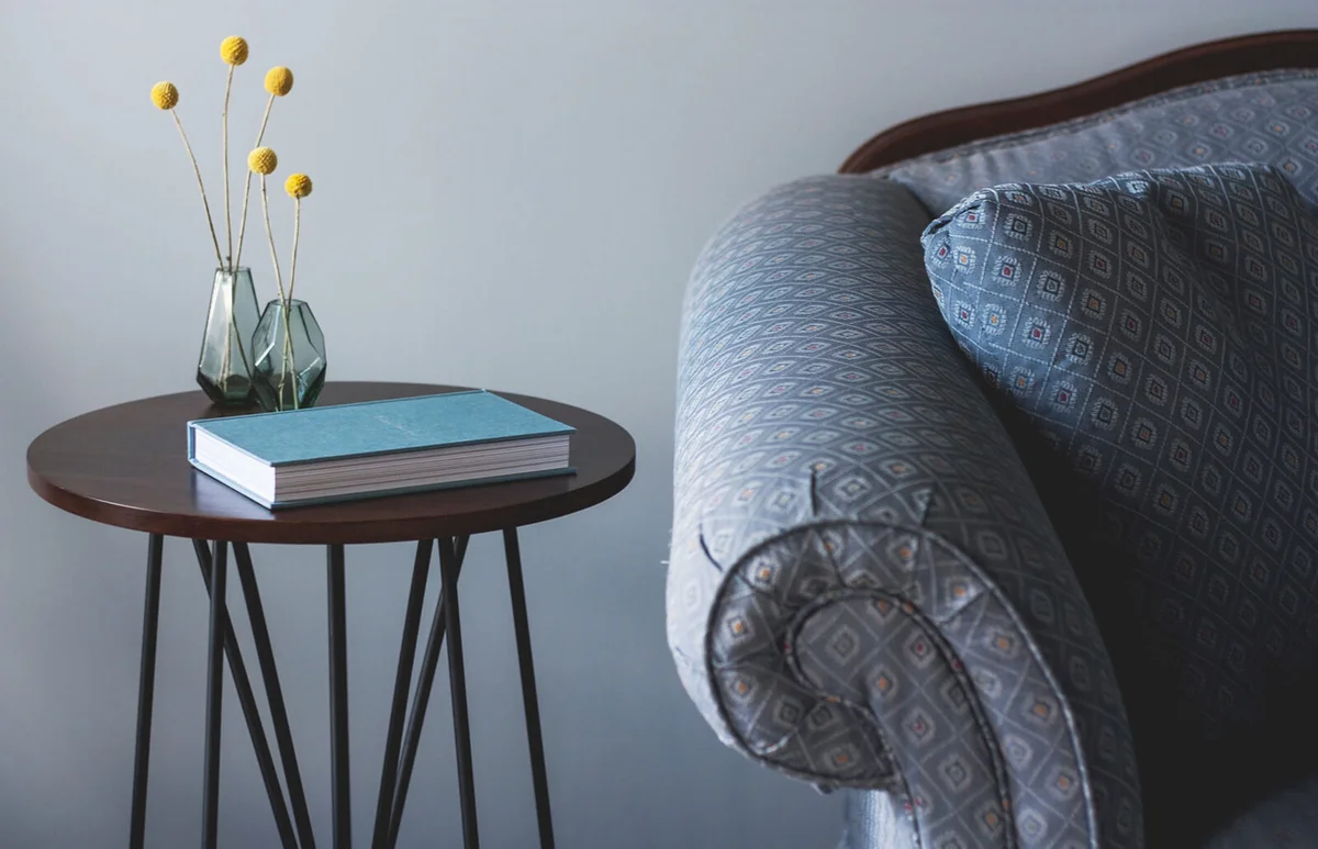 Book And Flower Vases On Side Table