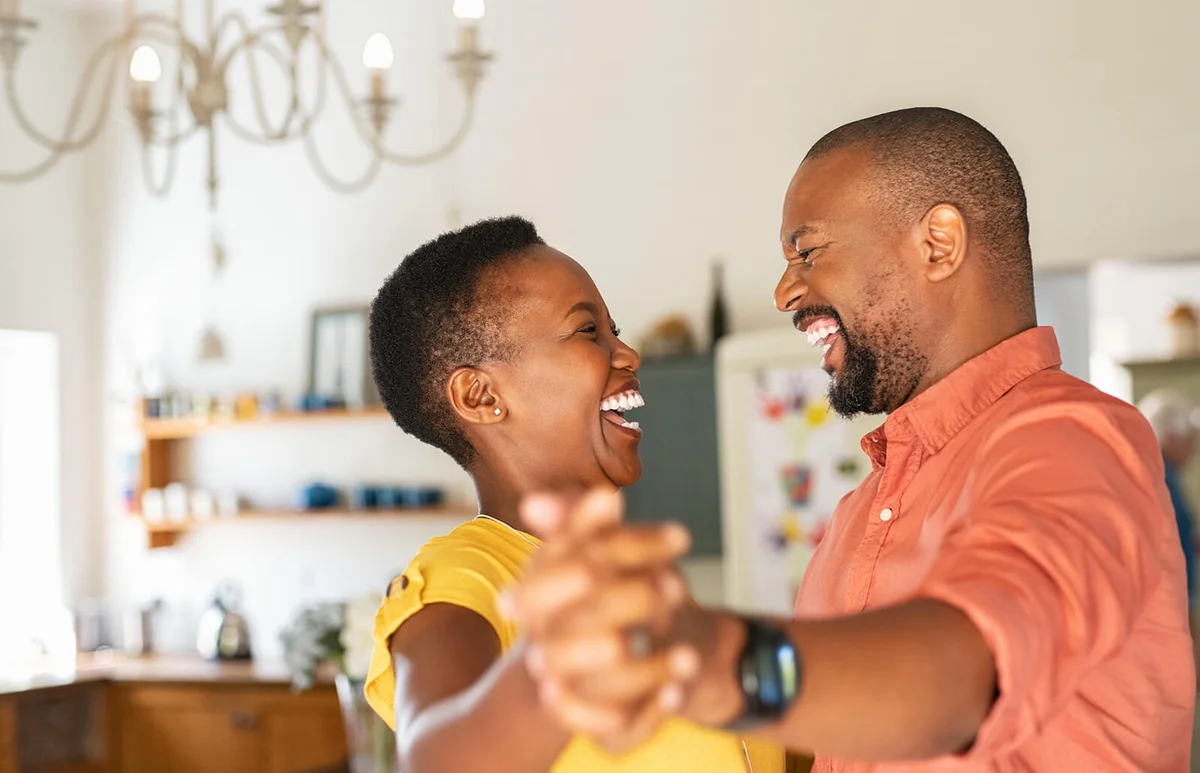 Mature happy couple dancing at home