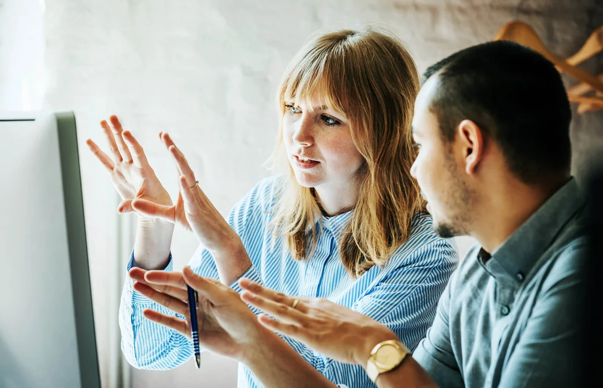 Colleagues Problem Solving At Computer Together