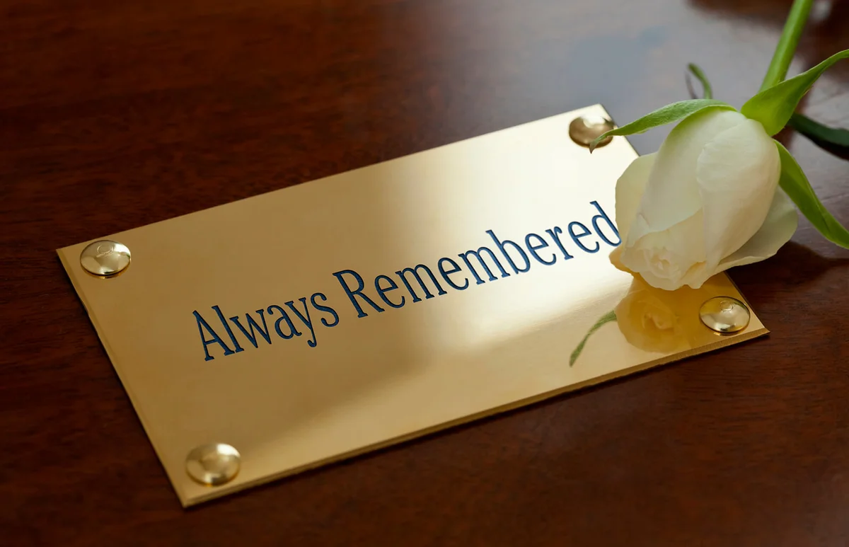 brass plaque bearing the enamelled inscription Always Remembered