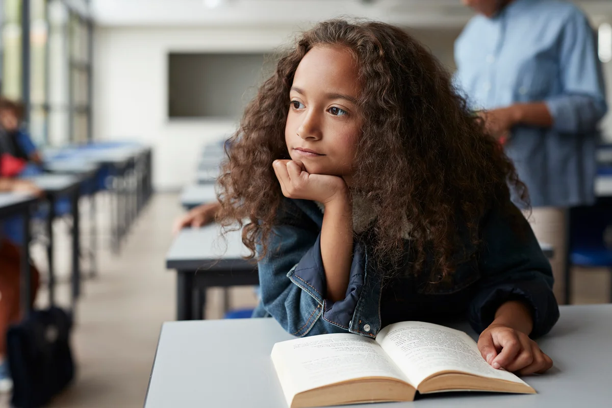 Girl daydreaming in classroom