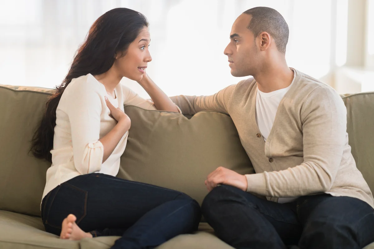 Woman having discussion with man
