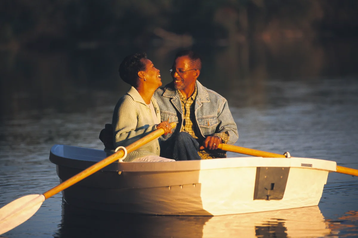 Woman laughing with man in row boat