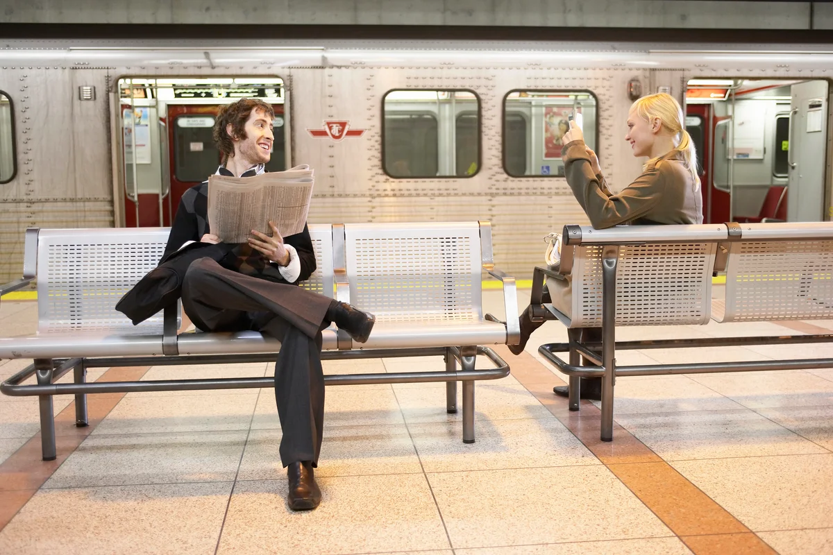 Man and woman flirting on subway platform