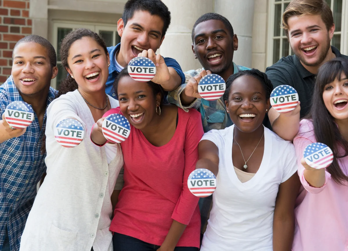Group of people holding Vote buttons