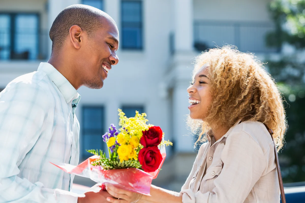 Man giving woman flowers