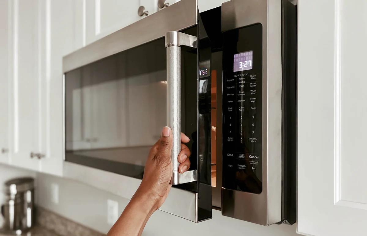Woman Opening Microwave