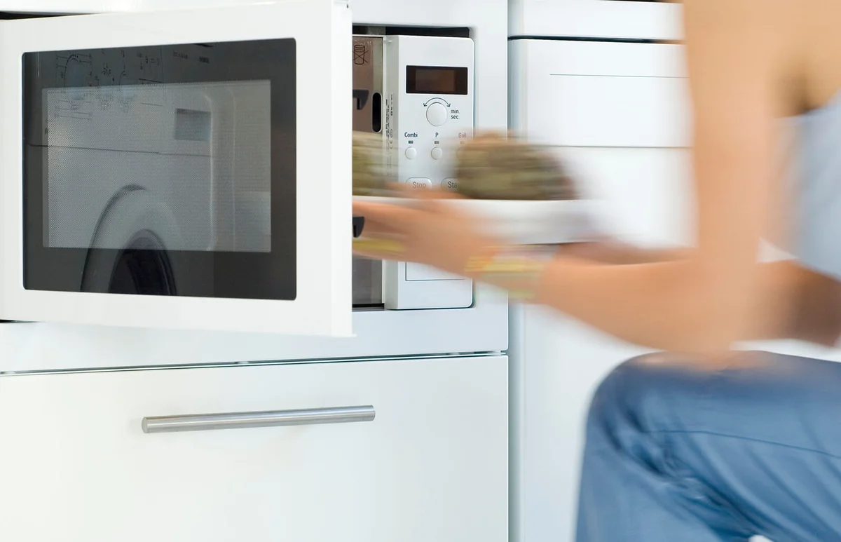 Woman using a microwave