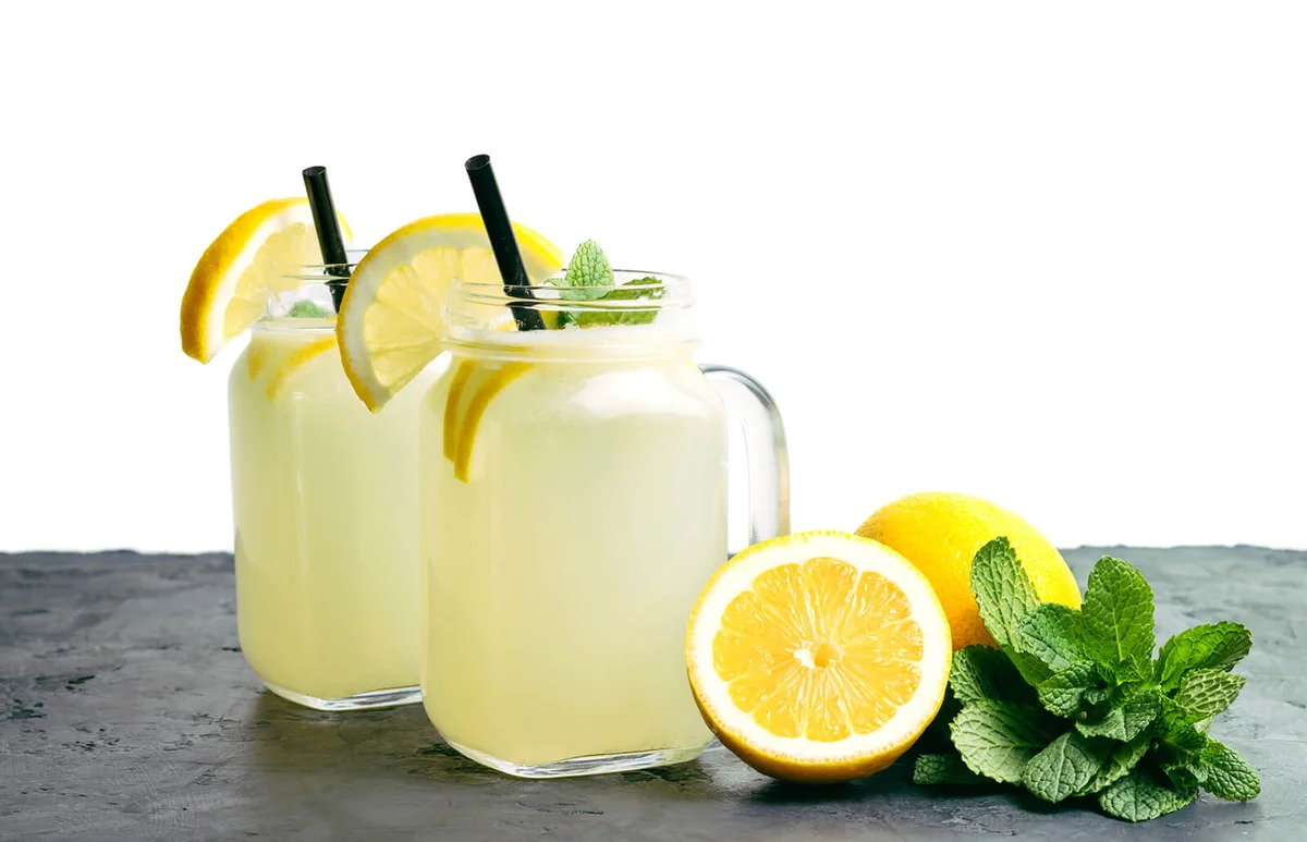 Refreshing lemonade drink with lemon slice and mint in the jar