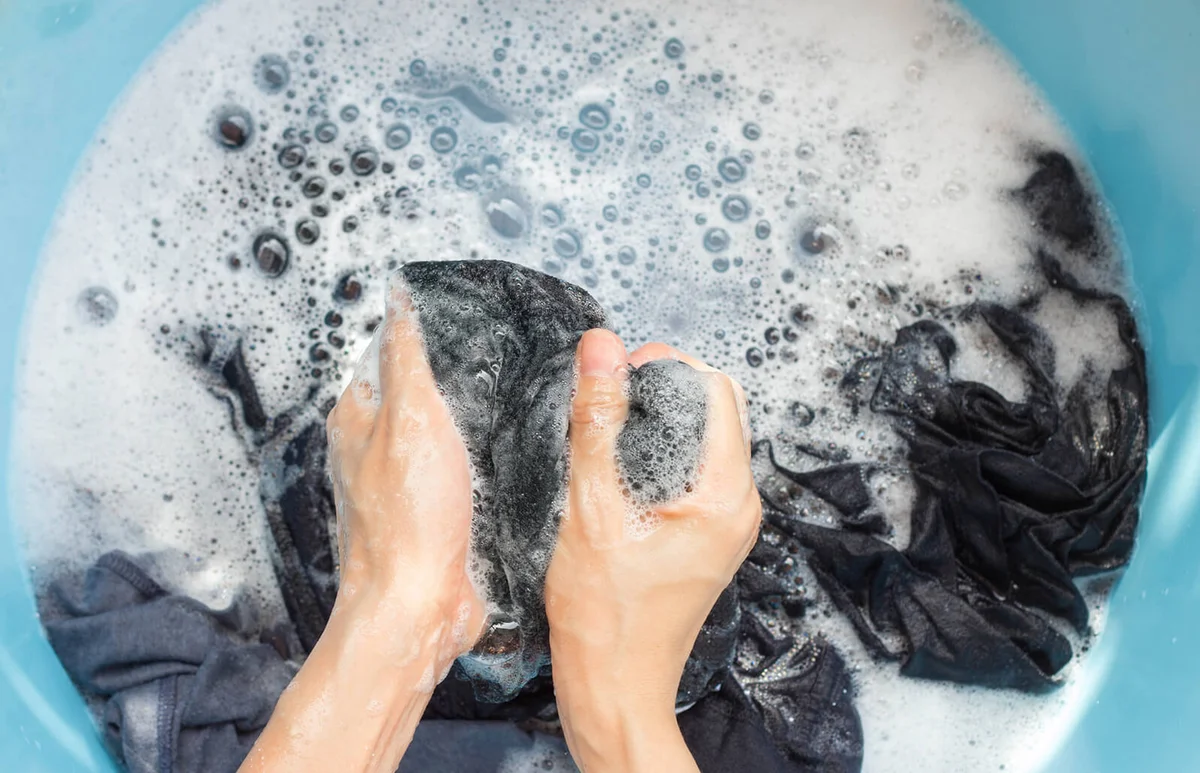 Hands Of Person Washing Laundry In Bucket