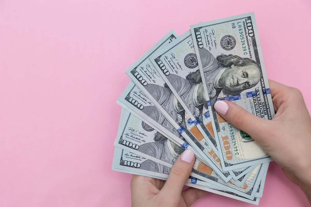 Woman county hundred dollar bills
