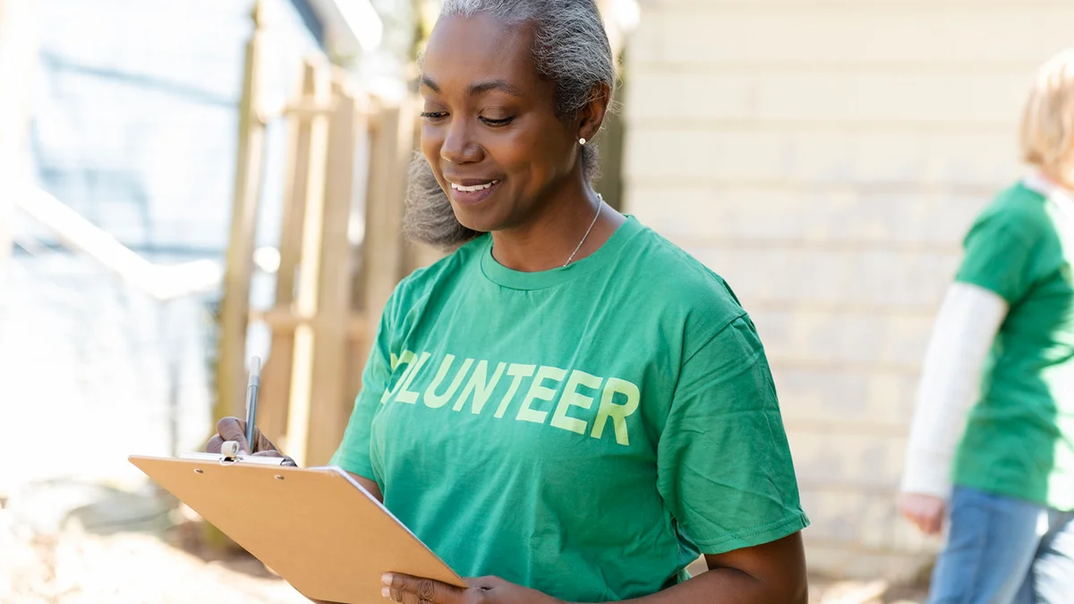 Mature woman volunteer with clipboard