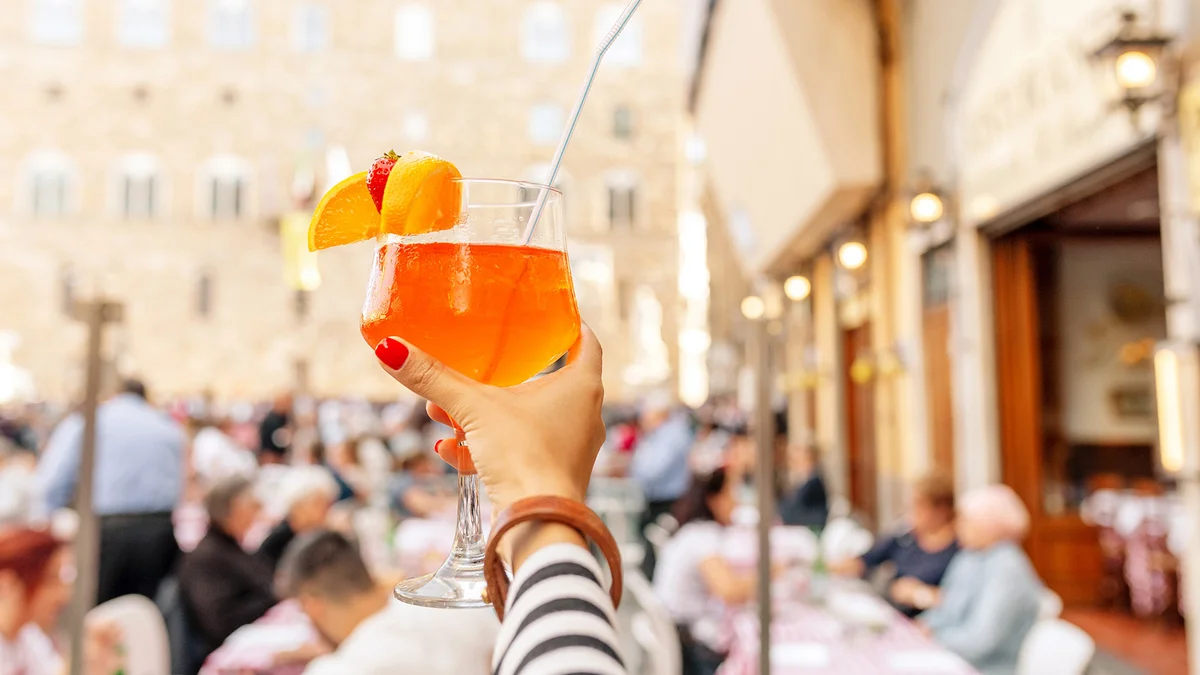 Aperol spritz cocktail decorated with orange and strawberry