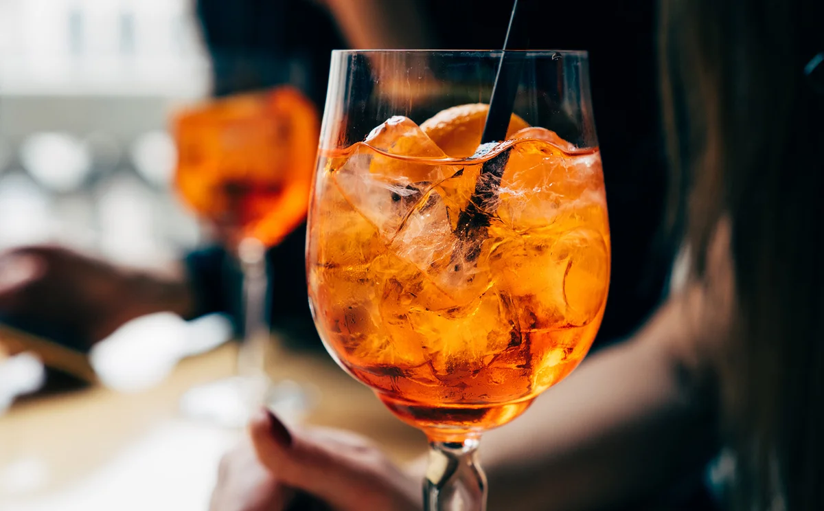 Two women with aperol spritz drinks