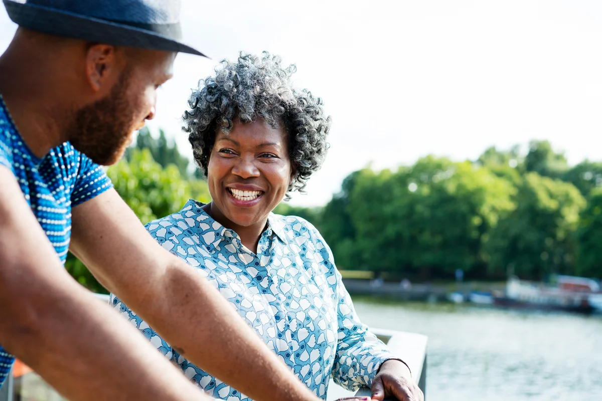 Woman and man talking by water