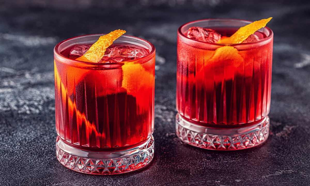 Negroni cocktail with orange peel and ice