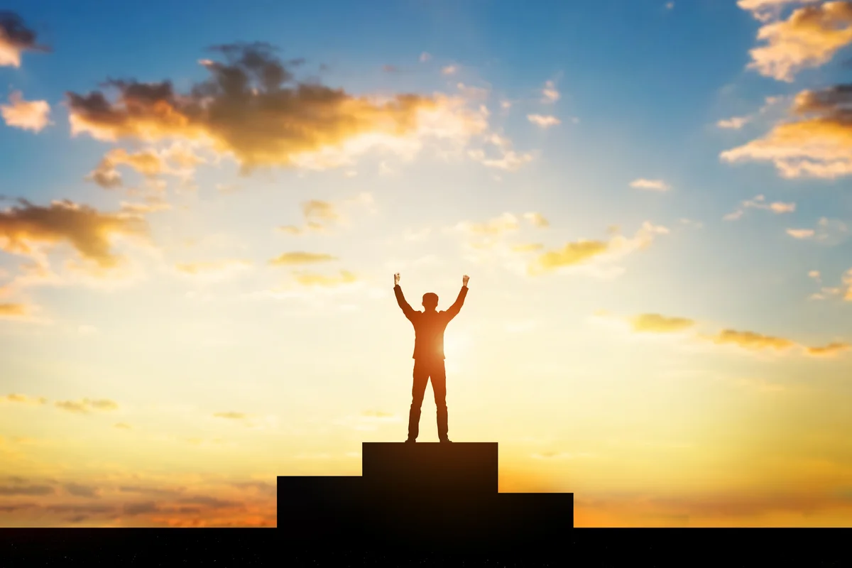 Man with arms raised in air