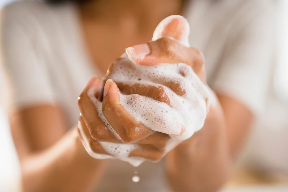 Person lathering hands with soap