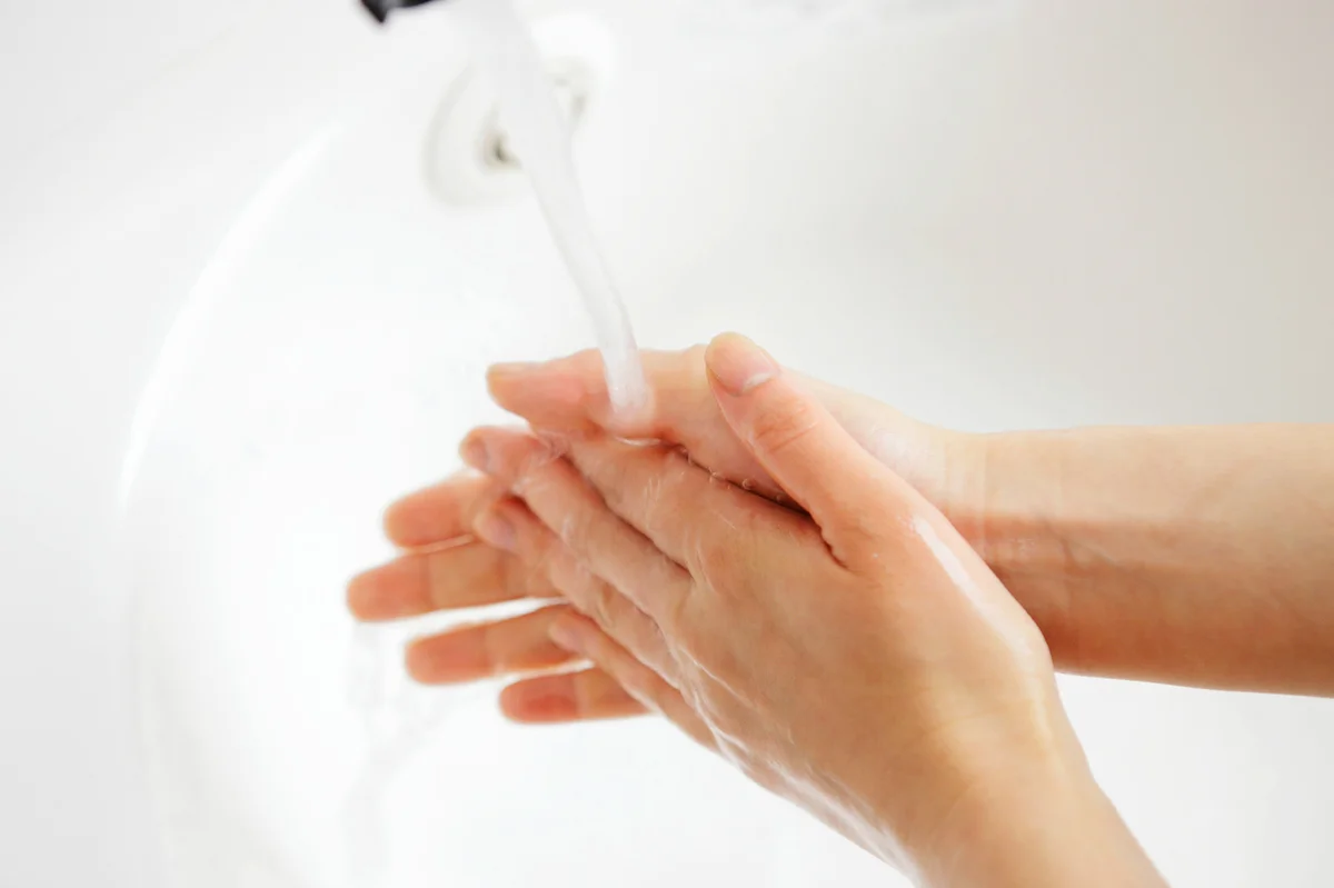 Person wetting hands with water