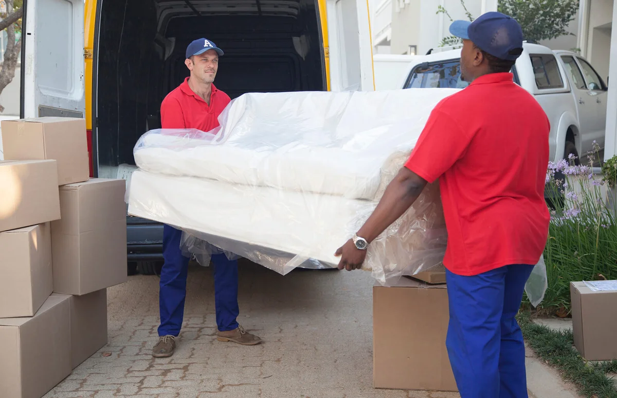 Movers carrying sofa to new home