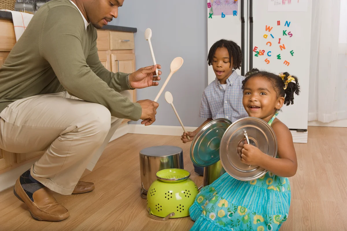 Family playing with pots and pans as drums