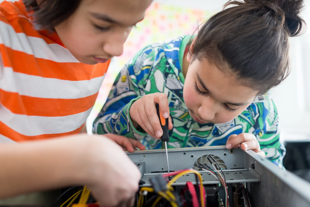 Two boys working with electronic equipments