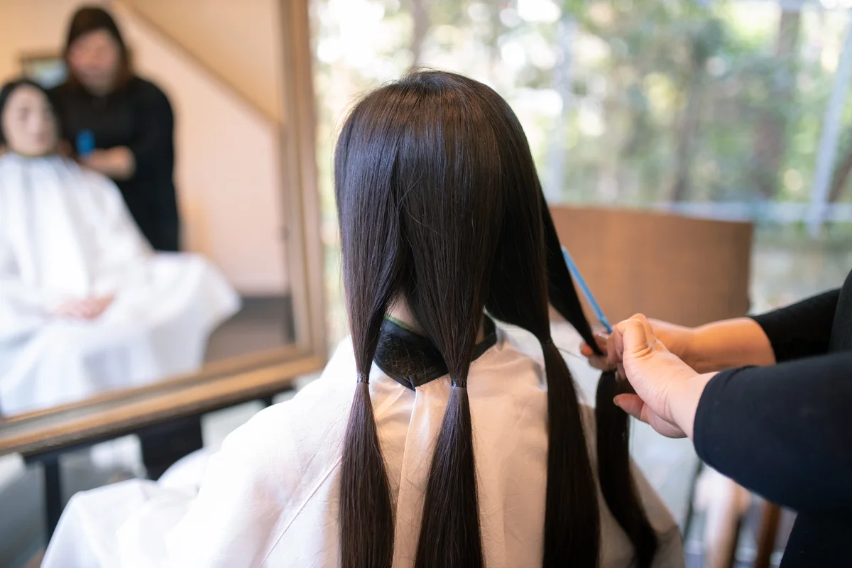 Woman cutting hair for donation