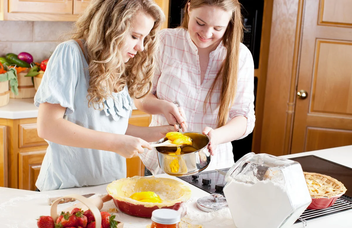 Teenage Girl Friends Making Homemade Fruit Pies