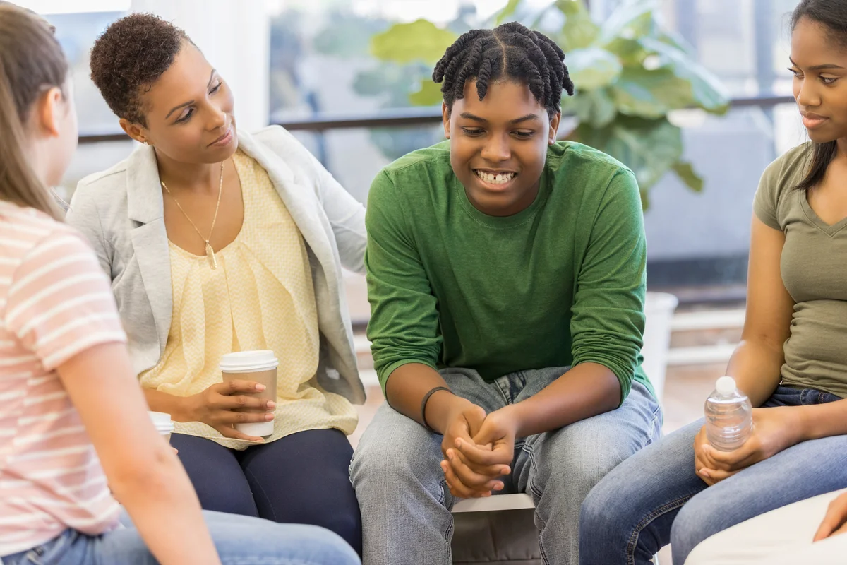 Trouble teenage boy discussing problems with family