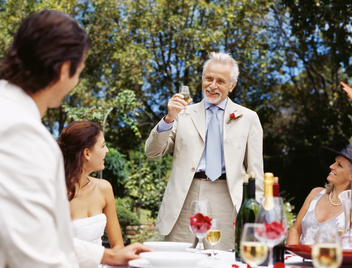 Father toasting couple at wedding