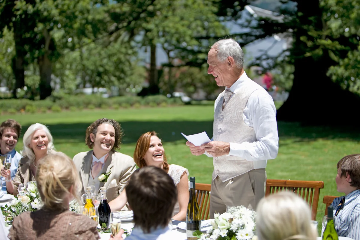 Father toasting couple at wedding