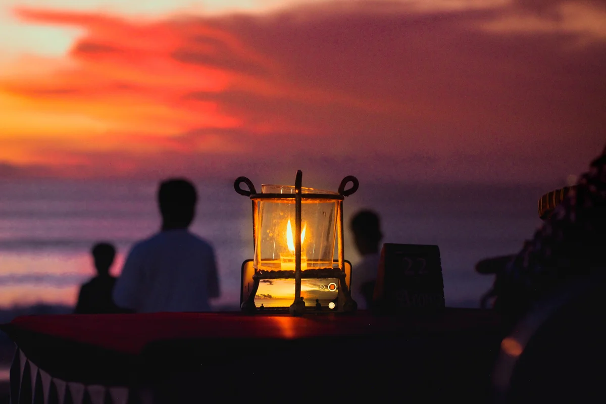 Beach illuminated at sunset by candle