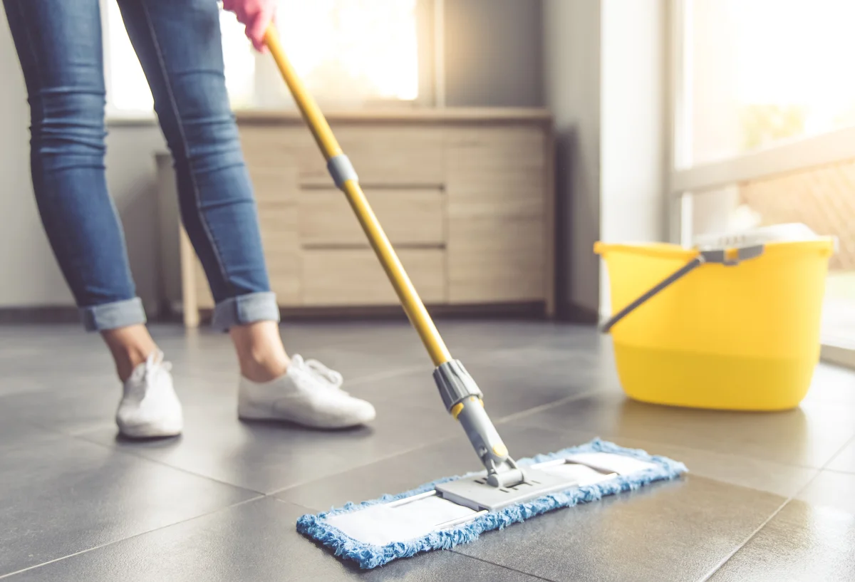 Woman dusting floor