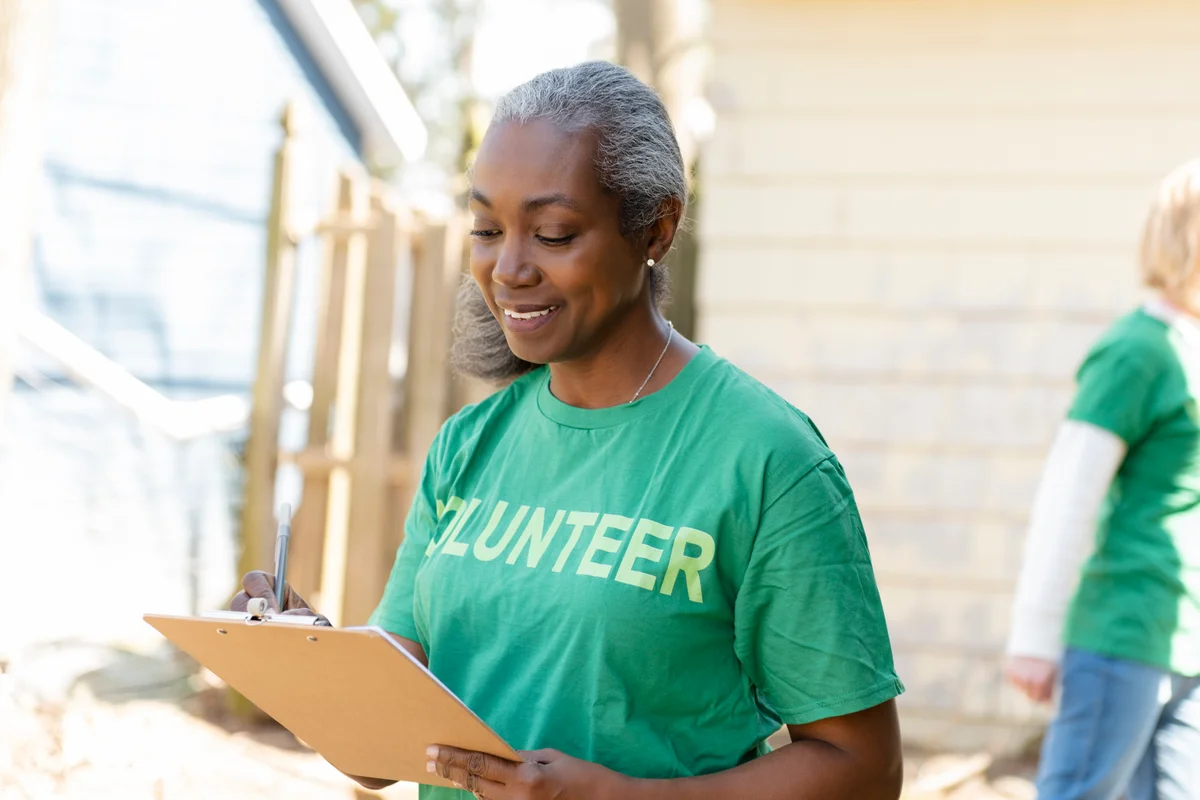Woman volunteer holding a clipboard