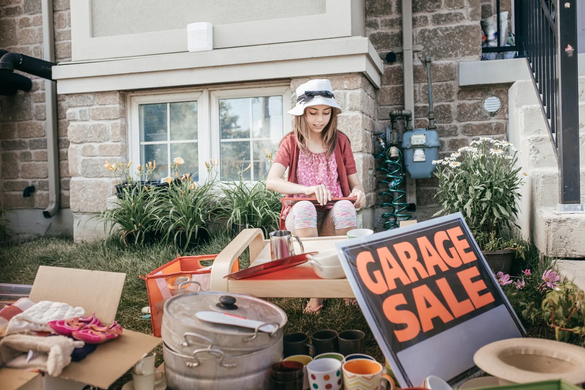 Young girl holding a garage sale for charity