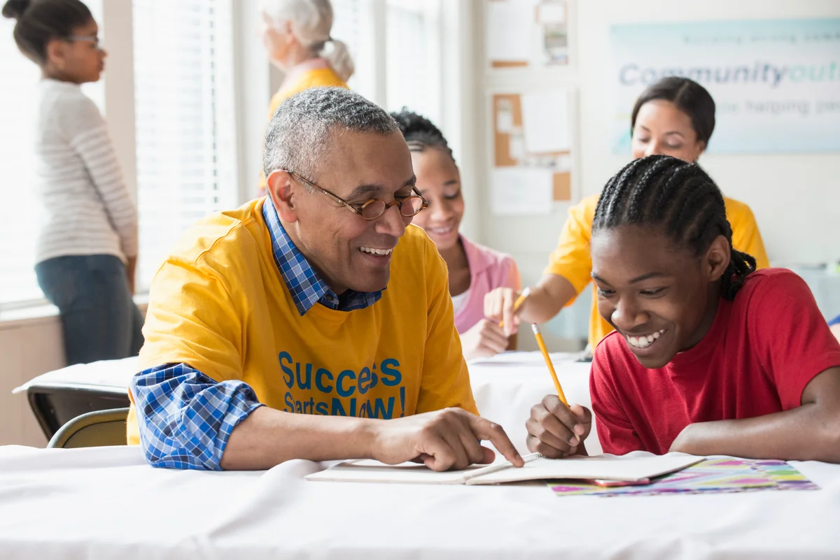 Senior man tutoring a student