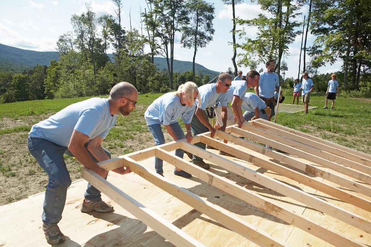 Construction volunteers building a house